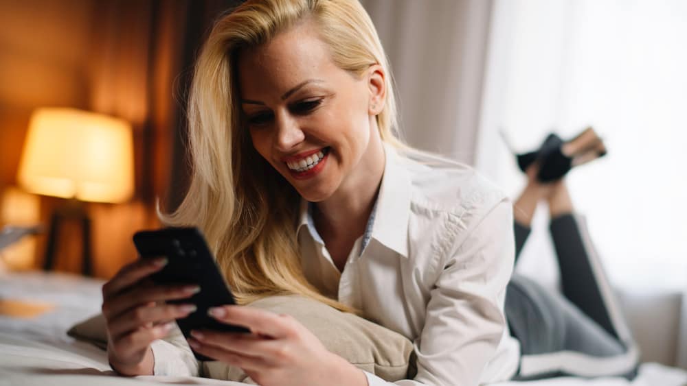 Businesswoman,Relaxing,After,Meetings,In,Hotel,Room.,Young,Beautiful,Women Hotel technology guest messaging 1
