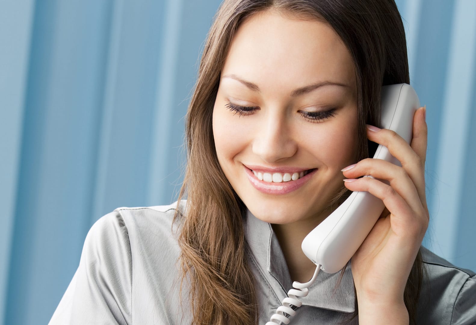 Young,Cheerful,Business,Woman,With,Phone,Writing,At,Office Hotel PBX phone 3