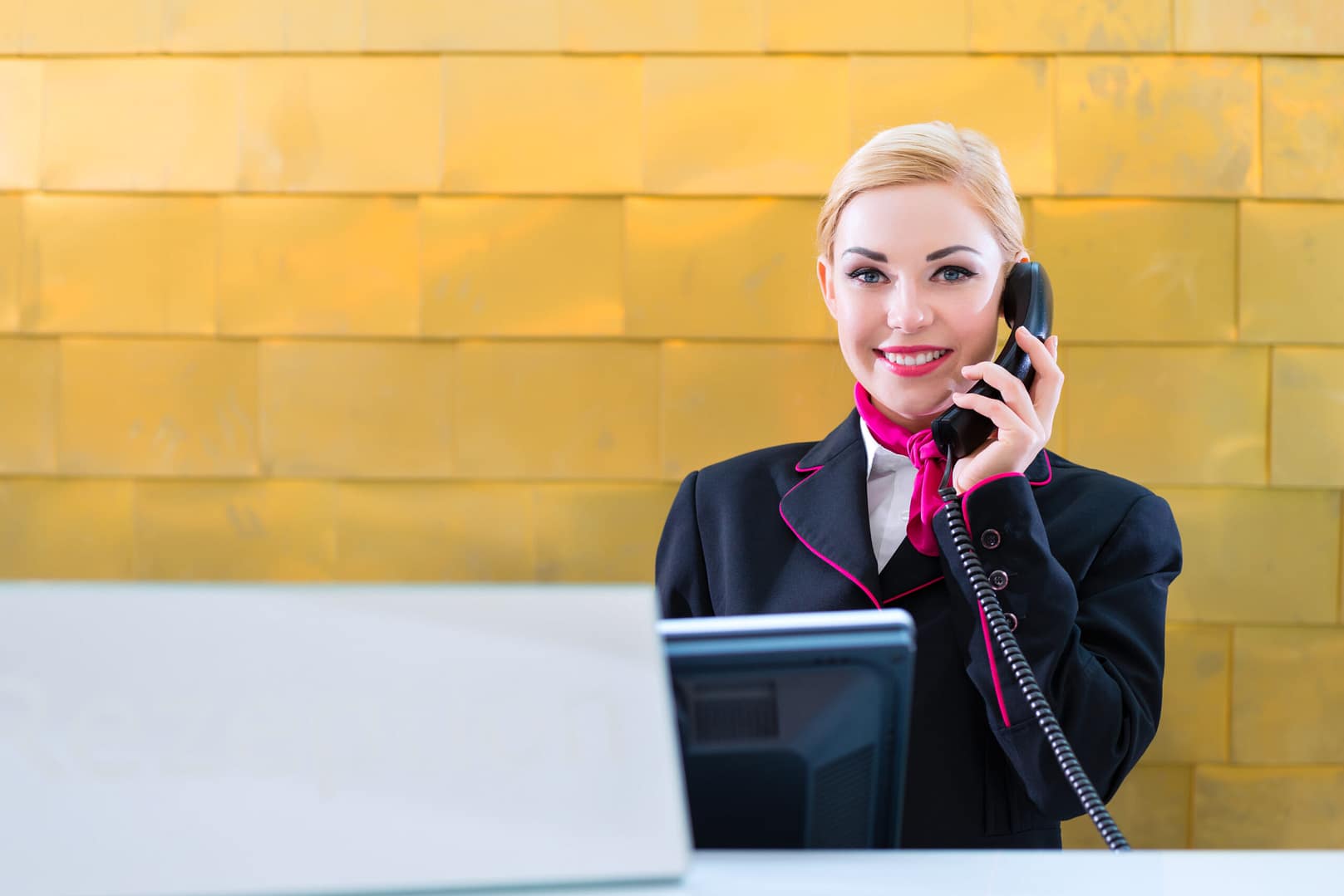 woman at front desk SIP Trunking for hotel phones 1