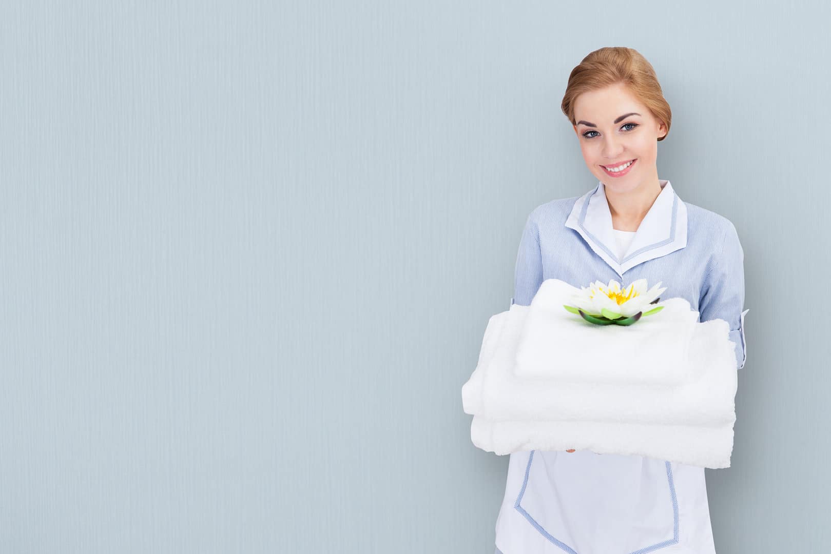 Portrait,Of,A,Young,Maid,Holding,Towels,Against,Colored,Background Hotel panic button systems