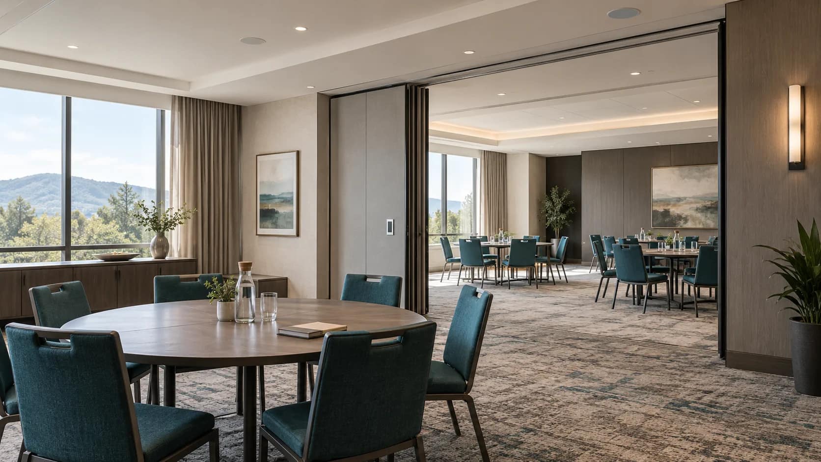 hotel-divisible-meeting-room-audio Illustrative hotel meeting suite with an open movable partition, ceiling speakers and a wall audio control