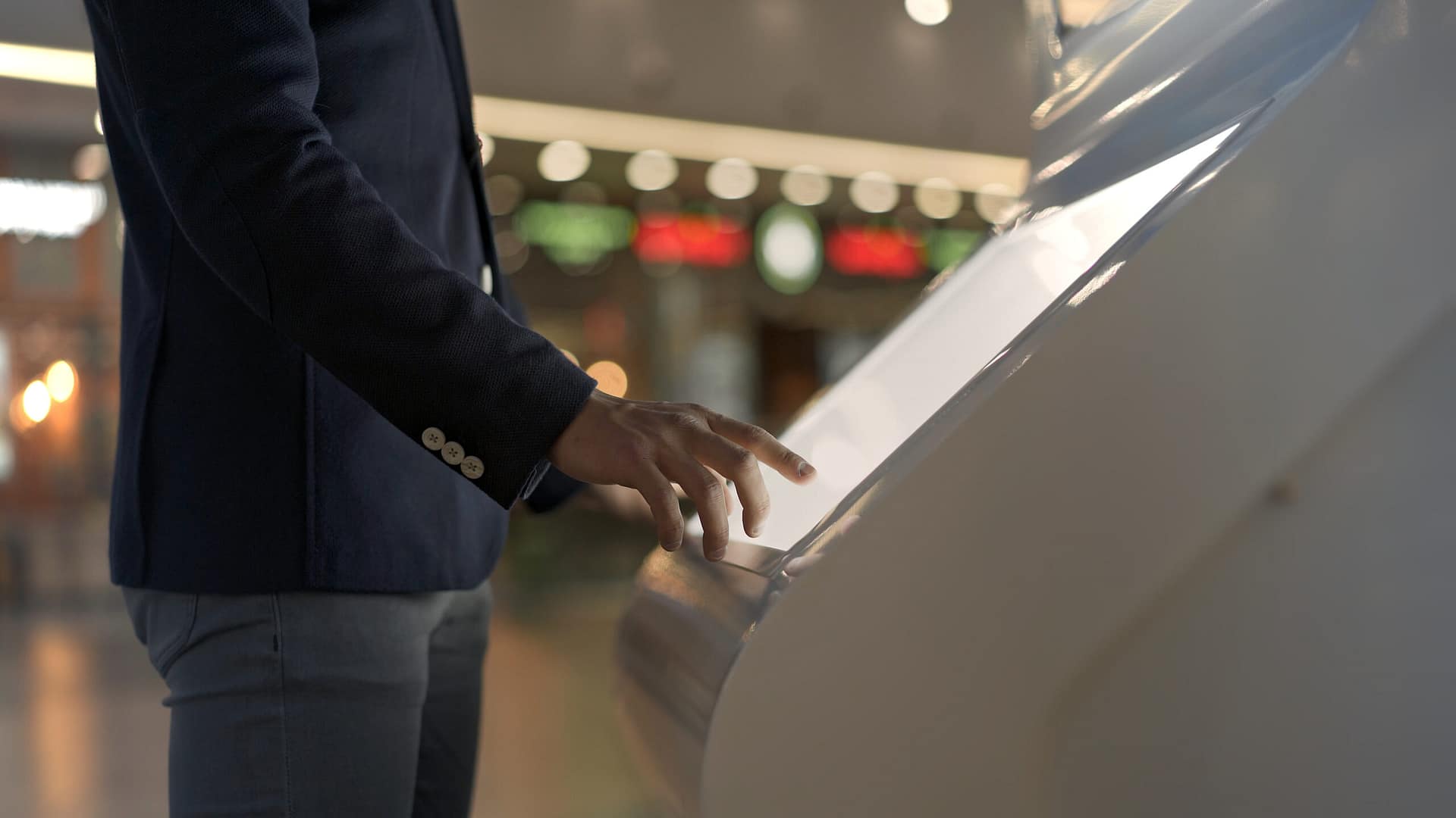 Young,Businessman,Hands,Dressed,In,Jacket,Swiping,For,Information,In Hotel technology kiosks 1